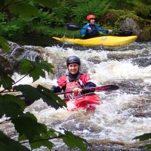 Adult Kayakers on the River