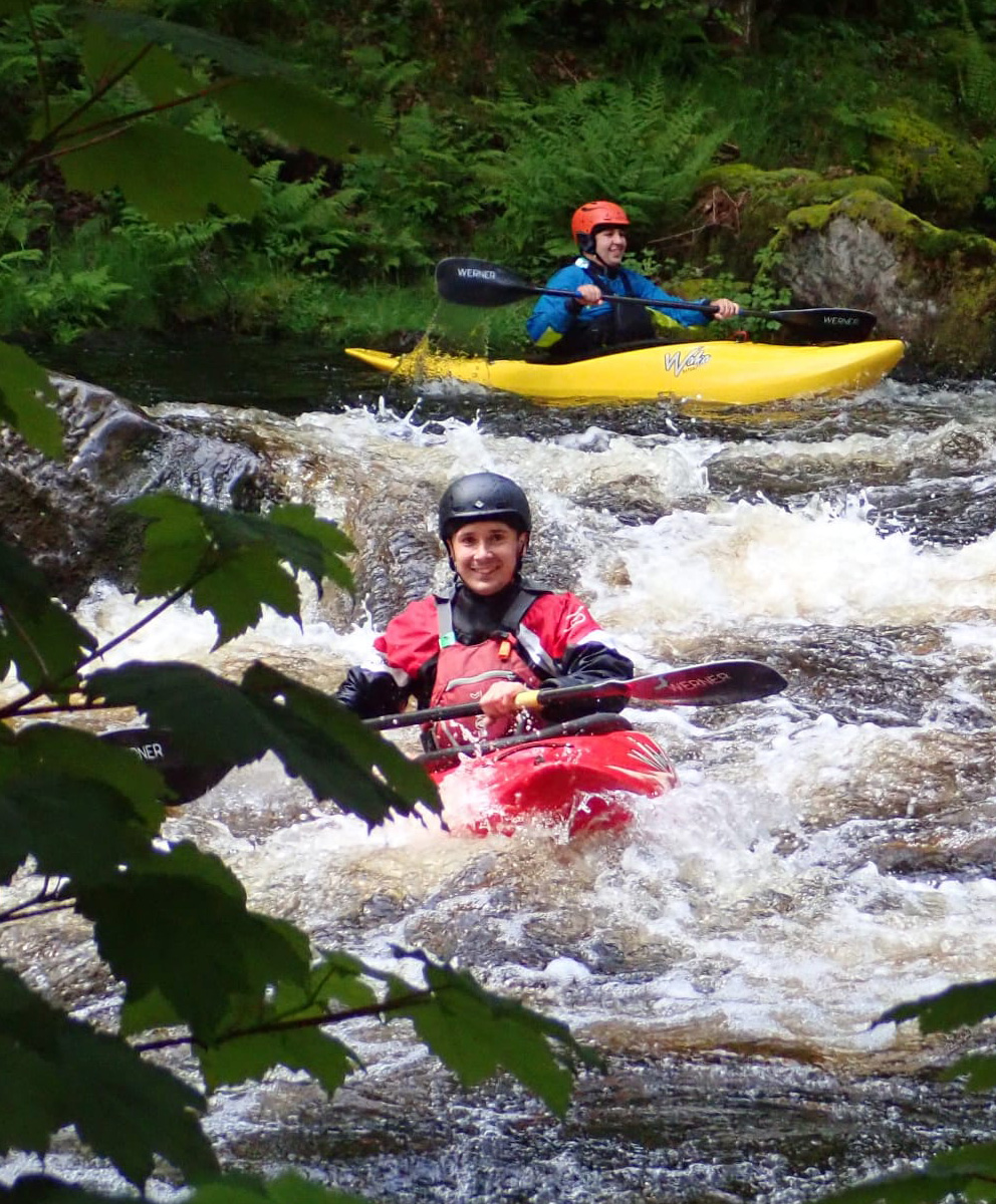 Adult Kayakers on the River