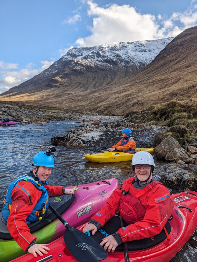 Group of kayakers on a white water leader course